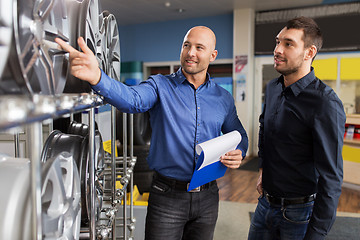 Image showing customer and salesman at car service or auto store