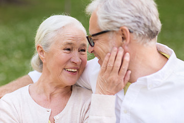 Image showing happy senior couple sitting on bench at park