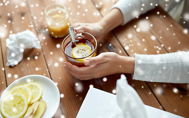 Image showing close up of ill woman drinking tea with lemon