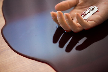 Image showing dead woman hand in blood on floor at crime scene