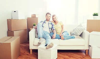 Image showing happy couple with big cardboard boxes at new home