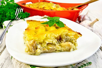 Image showing Gratin potato with fish in plate on table