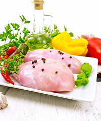 Image showing Chicken breast raw in plate on board