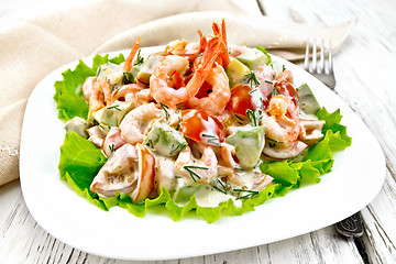 Image showing Salad with shrimp and tomato in plate on light board