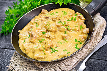 Image showing Meat stewed with cream in pan on board
