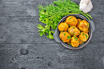 Image showing Meatballs in brazier on black board top