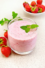 Image showing Milkshake strawberry with berries on granite table