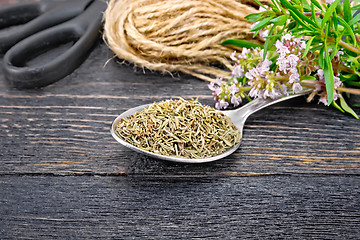 Image showing Thyme dry in spoon with scissors on board