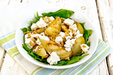 Image showing Salad from pear and spinach with feta in dish on light board