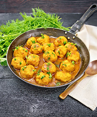 Image showing Meatballs in pan with sauce on black board