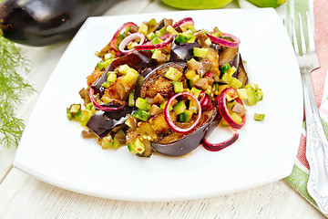 Image showing Salad from eggplant and cucumber in plate on light board