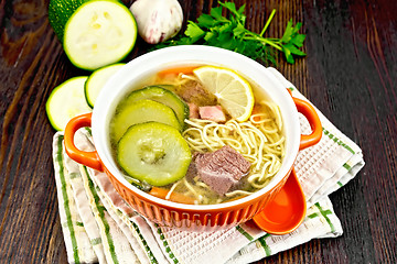 Image showing Soup with zucchini and noodles in bowl on dark board