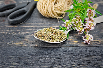 Image showing Thyme dry in spoon with twine on black board