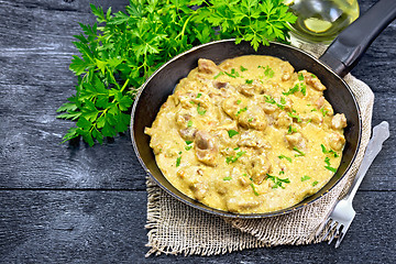 Image showing Meat stewed with cream in pan on black board