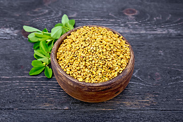 Image showing Fenugreek with green leaf in clay bowl on board