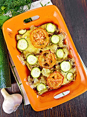 Image showing Casserole from minced meat and zucchini in brazier on dark board