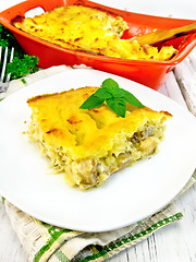 Image showing Gratin potato with fish in plate on napkin