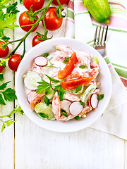 Image showing Salad from fresh vegetables in plate on light board top