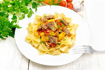 Image showing Farfalle with turkey and vegetables in plate on board