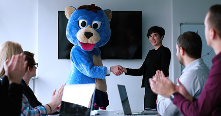 Image showing boss dresed as bear having fun with business people in trendy of