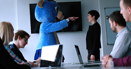 Image showing boss dresed as bear having fun with business people in trendy of