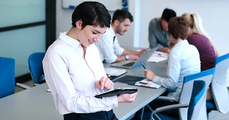 Image showing Portrait of  smiling casual businesswoman using tablet  with cow