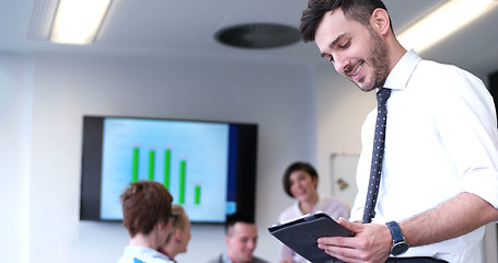 Image showing Businessman using tablet in modern office