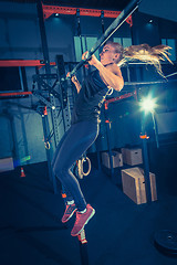 Image showing Concept: power, strength, healthy lifestyle, sport. Powerful attractive muscular woman at CrossFit gym