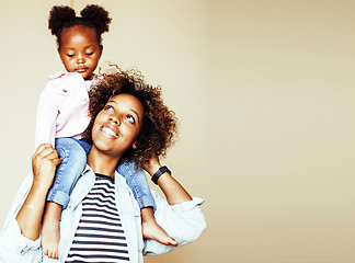 Image showing adorable sweet young afro-american mother with cute little daughter, hanging at home, having fun playing smiling, lifestyle people concept 