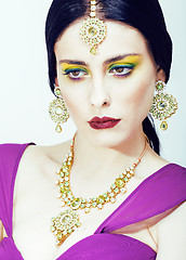 Image showing young pretty caucasian woman like indian in ethnic jewelry close up on white, bridal bright makeup fashion people