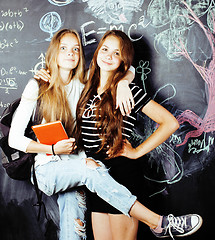 Image showing back to school after summer vacations, two teen real girls in classroom with blackboard painted together, lifestyle people concept