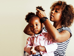 Image showing adorable sweet young afro-american mother with cute little daughter, hanging at home, having fun playing smiling, lifestyle people concept 