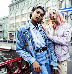 Image showing Two diverse race teenage girls infront of university building smiling, having fun, lifestyle real people concept