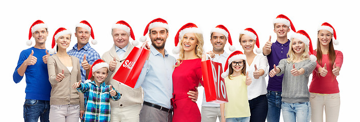 Image showing people in santa hats with sale sign at christmas