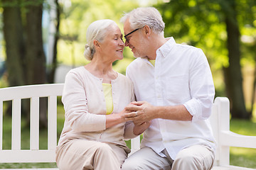 Image showing happy senior couple sitting on bench at park