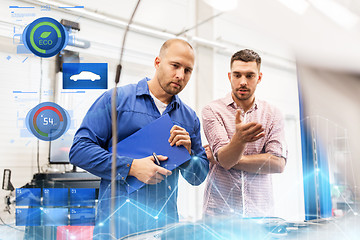 Image showing auto mechanic with clipboard and man at car shop