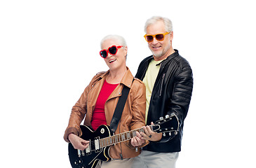 Image showing senior couple in sunglasses with electric guitar