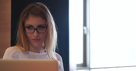 Image showing woman freelancing from home and drinking caffee