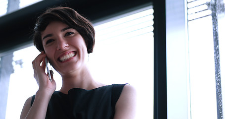 Image showing Business Girl Standing In A Modern Building Near The Window With