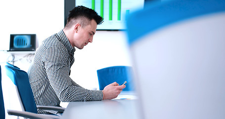 Image showing Senior businessman  using cell phone at  stratup office