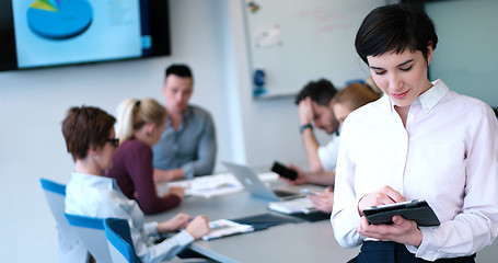 Image showing Portrait of  smiling casual businesswoman using tablet  with cow