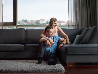 Image showing Attractive Couple Using A Laptop on couch