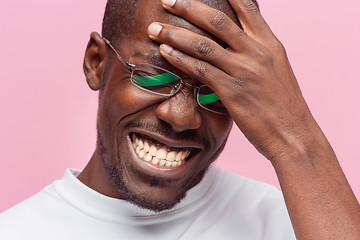 Image showing Black man holding his head in pain and depression