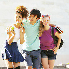 Image showing cute group of teenages at the building of university with books huggings, back to school