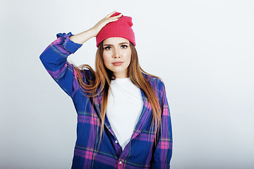 Image showing young pretty teenage hipster girl posing emotional happy smiling on white background, lifestyle people concept 