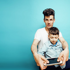 Image showing young pretty man model with little cute son playing together, lifestyle modern people concept, family male close up