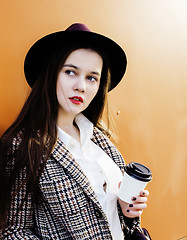 Image showing young pretty hipster girl student with coffee cup posing adorable smiling, lifestyle people concept outdoor 