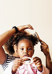 Image showing adorable sweet young afro-american mother with cute little daughter, hanging at home, having fun playing smiling, lifestyle people concept, happy smiling modern family 