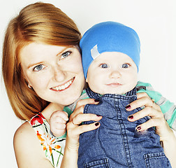 Image showing young beauty mother with cute baby, red head happy modern family smiling isolated on white background close up, lifestyle people concept