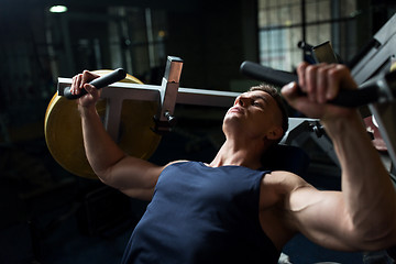 Image showing man doing chest press on exercise machine in gym